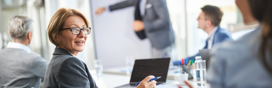 Senior businesswoman talking to her colleague in the office.